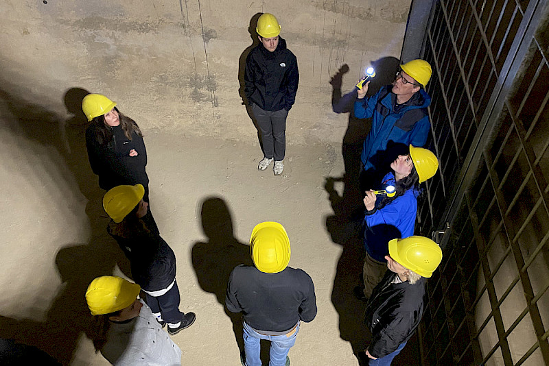 Vor Ort recherchiert: Studierende erkunden gemeinsam mit Gedenkstättenleiter Gero Fedtke die historischen Stollenanlagen des ehemaligen KZ Langenstein-Zwieberge.